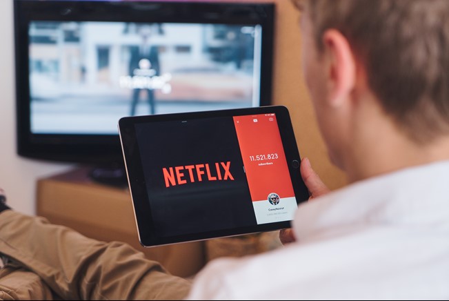 Man viewing netflix in the tablet