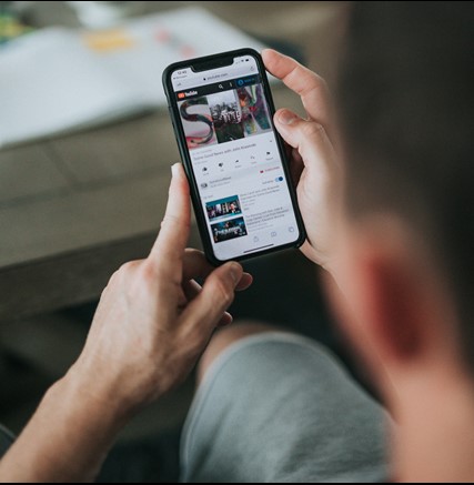 Man using mobile, watching youtube