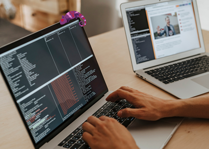 Man typing, coding, posing for photo