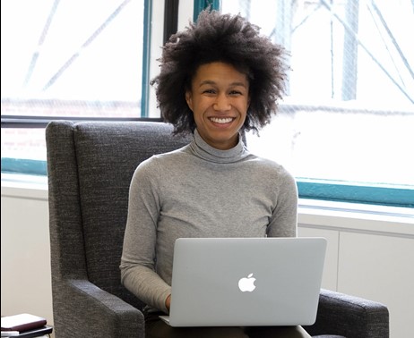 Man typing, smiling, posing for photo