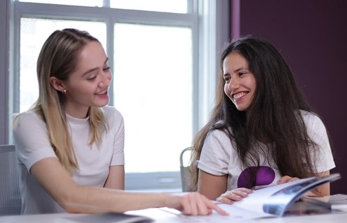 Two Women smiling, posing for photo