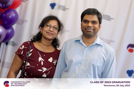 Men and woman smiling, posing for a photograph