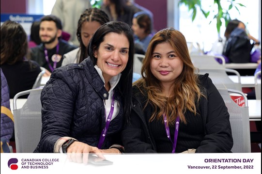 
Two Women smiling, wearing ID card, posing for photo