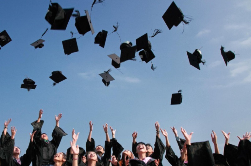 Graduated flying there hats in the sky with happiness