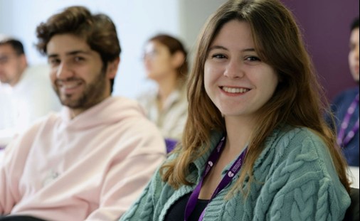 Woman and man smiling, posing for photo