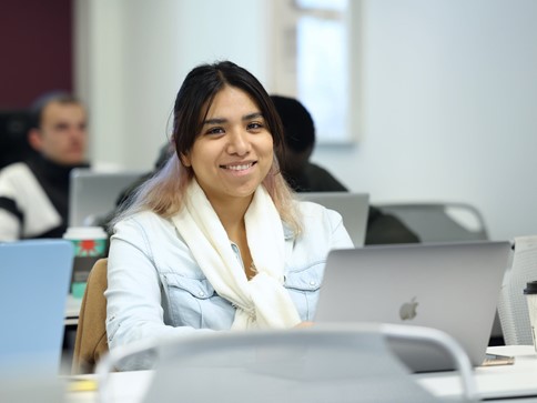 Woman smiling, typing, posing for photo