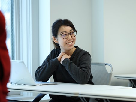 Woman smiling, wearing glasses, posing for photo