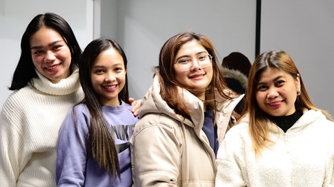 Group smiling, standing and posing for a photograph