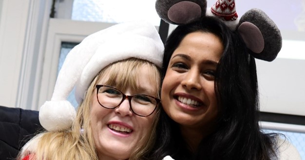 Two Women smiling, wearing glasses, posing for photo