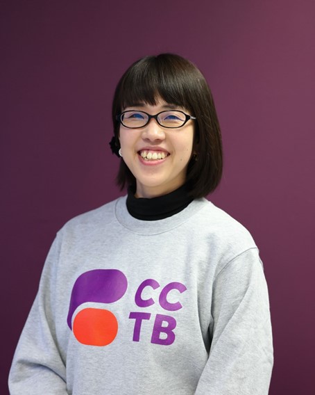Woman smiling, wearing glasses, posing for photo