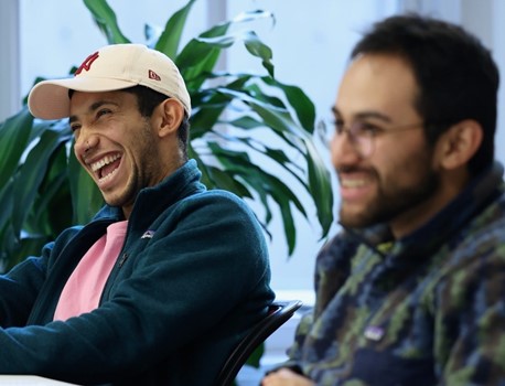 Man smiling, wearing glasses, posing for photo