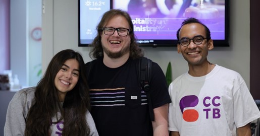 Group smiling, wearing glasses, posing for photo
