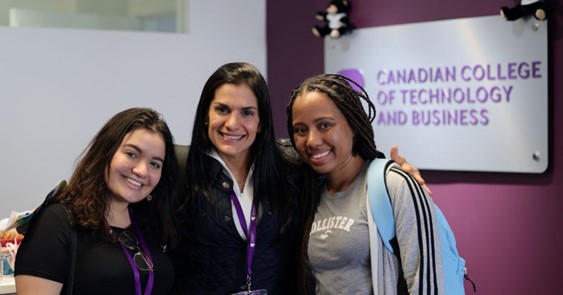 
Group smiling, standing and posing for a photograph