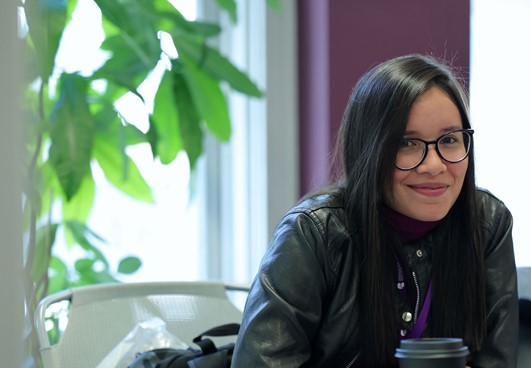 Woman smiling, wearing glasses, posing for photo