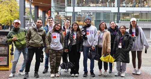 Group smiling, standing and posing for a photograph