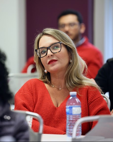 
Woman smiling, wearing glasses, posing for photo