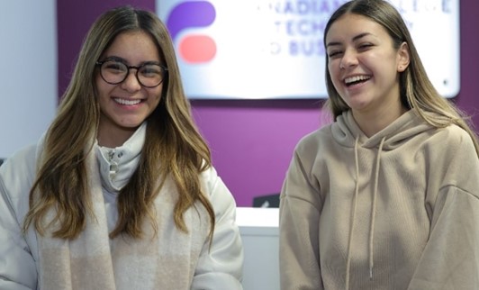 Two Women smiling, wearing glasses, posing for photo