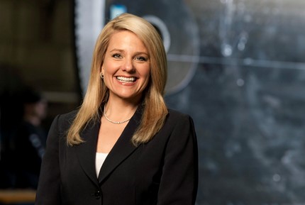 Gwynne Shotwell - smiling, posing for the photograph