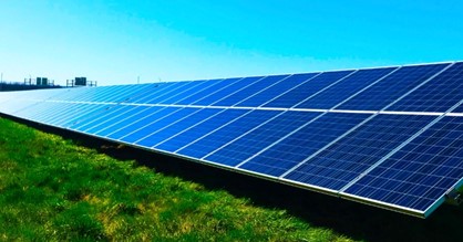 Solar panels slantly grounded on the green earth