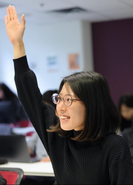 Woman smiling, Raising hand, posing for a photograph