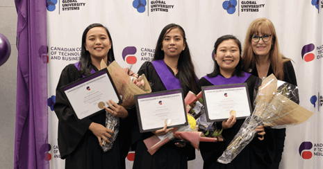Group smiling, graduation day, posing for photo