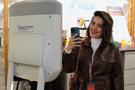 Woman smiling, clicking a selfie in her mobile