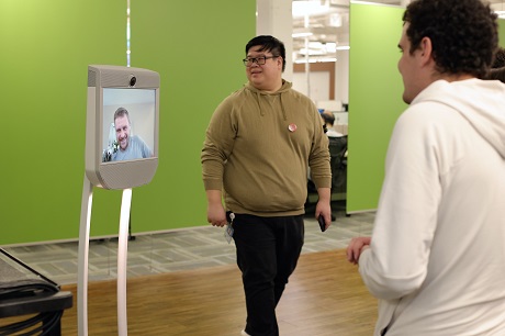 Man looking at Beam telepresence Robot