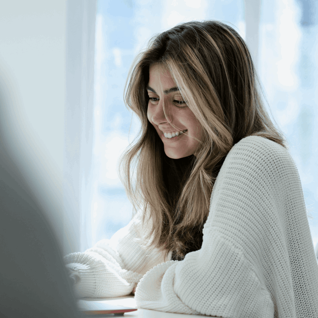 Beautiful woman smiling, typing, posing for a photo