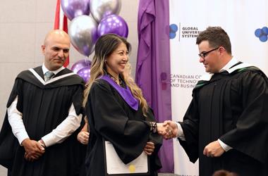 Campus director shaking hands with student