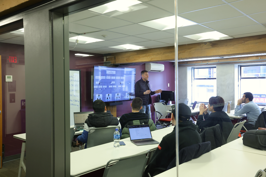 The instructor is explaining the topic to the students in the classroom