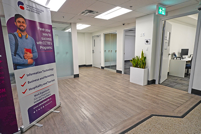 Campus hallway with offices and glass doors