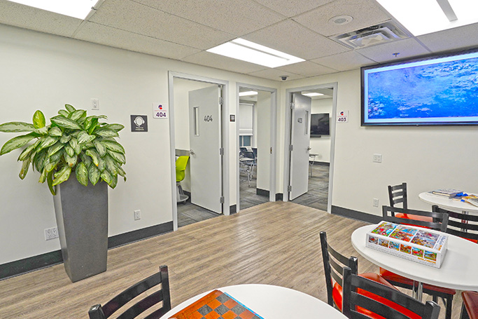 Student lounge with tables and plant